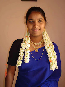 Traditional Tamil girl in blue saree with head full of jasmine flowers.