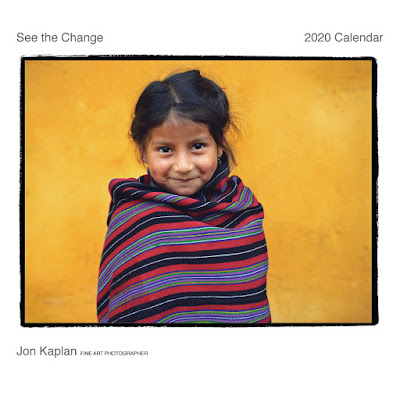 Seva 2020 calendar which says "see the change" and identifies Jon Kaplan as the photographer; photo is of a little girl