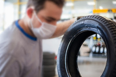 Man checking a car tyre