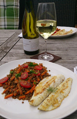 A dish with fish and lentils together with a Pinot Blanc aka Weissburgunder