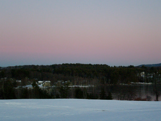 Lake near Meredith, New Hampshire at sunset in winter.