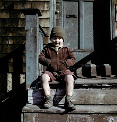 1947 color photograph of boy on steps with hand in pockets