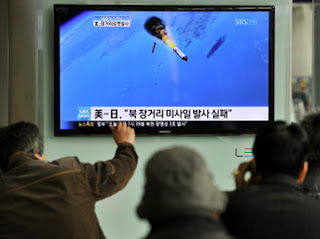 Người dân Hàn Quốc theo dõi vụ phóng vệ tinh của CHDCND Triều Tiên qua màn hình tivi ở một nhà ga tại Seoul vào ngày 13.4