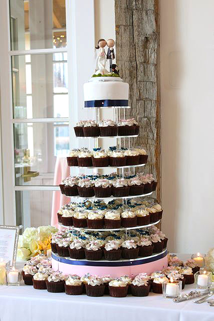 The cupcake tower incorporated their wedding colors of light pink navy blue