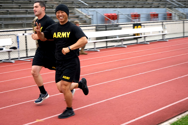 Sgt. 1st Class, Michael Yoon, 223rd Military Intelligence Battalion, flashes a smile while completing a two-mile run during an Army Combat Physical Fitness test