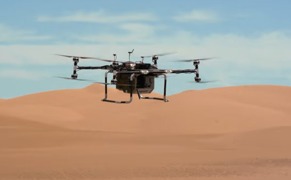 A video screenshot showing an engineering model of NASA's Dragonfly quadcopter beginning a flight test above California's Imperial Dunes...in May of 2022.