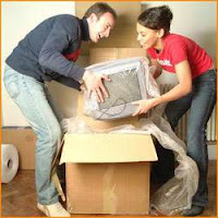 two men and women unpacking some boxes