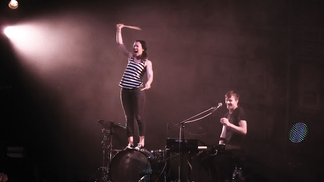 Kim, of Matt and Kim, standing on her drum during a performance at the Ogden Theater in Denver.