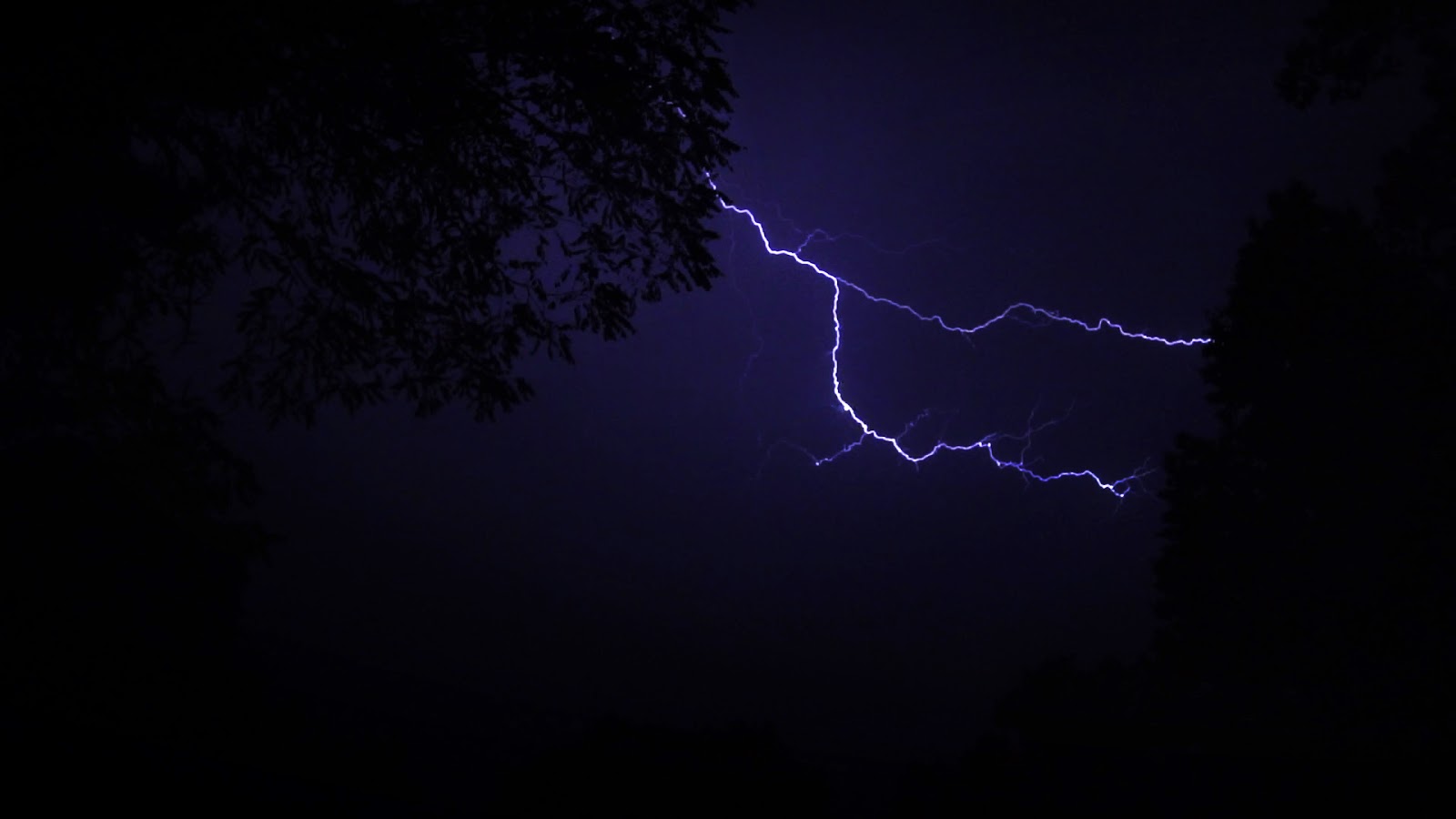 A brief still of a longer and available stock footage clip of a lightning storm.