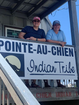 Alyssa Outhwaite (left) and Becky Allee (right) in front of the  Point-au-Chien Indian Tribe Building