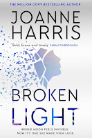 The cover of Broken Light by Joanne Harris showing a blue profile fragmenting on a white background