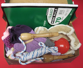 Adding a spiral notebook to a full Operation Christmas Child shoebox.