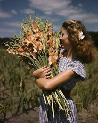 Old photo of a woman holding flowers
