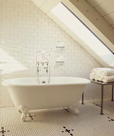 master bathroom with mosaic tiles, a claw foot stand alone tub and floor to ceiling white subway tiles