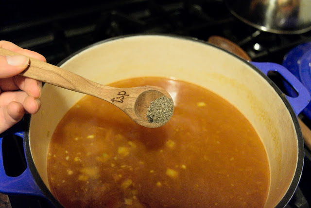 Pepper being added to the soup. 