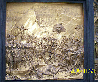 Brass panel on the door to the Baptistry.