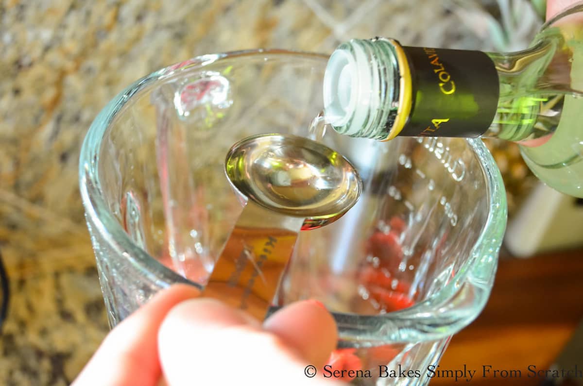 Champagne Vinegar being measured over a glass blender.