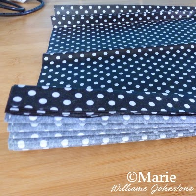 black polka dot tissue paper being folded up for a decorative craft