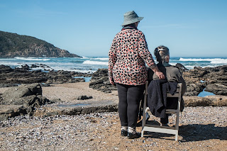 Elderly couple looking into the ocean
