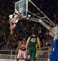 A Harlem Globetrotter does a slam-dunk