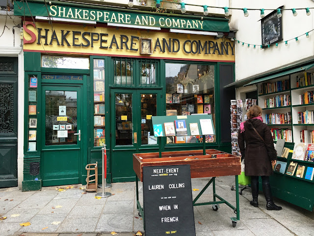 woman picking out books outside the bookstore