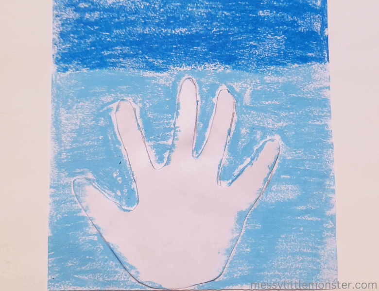 use pastels to create background for snowman handprint