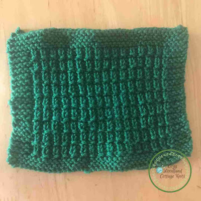 Picture of knitted hurdle stitch square with a garter stitch border
