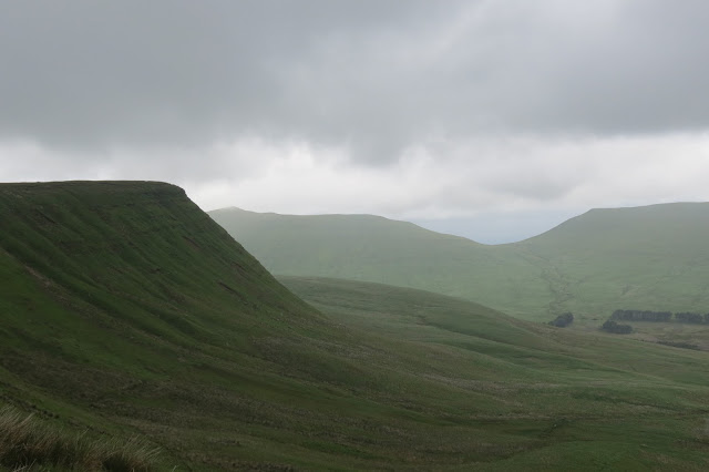 A misty shot of mountain summits around the valley.