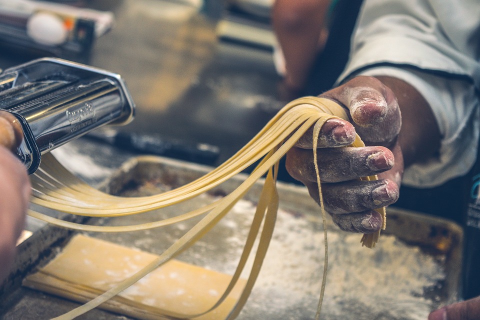 Cook preparing delicious pasta