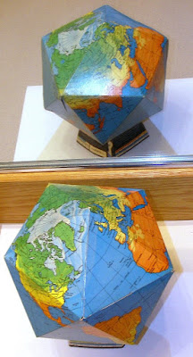 Cardboard folded up dymaxion globe using Fuller Projection 1967