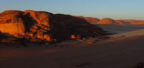 Setting sun casts a golden glow on the desert camps of Wadi Rum, Jordan