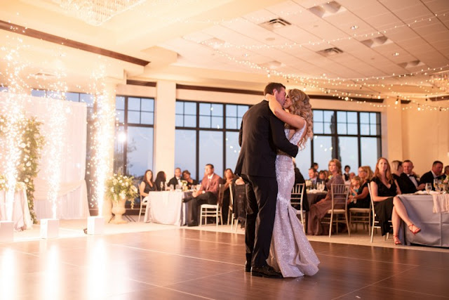 bride and groom kissing on the dancefloor with cold sparks shooting up behind them