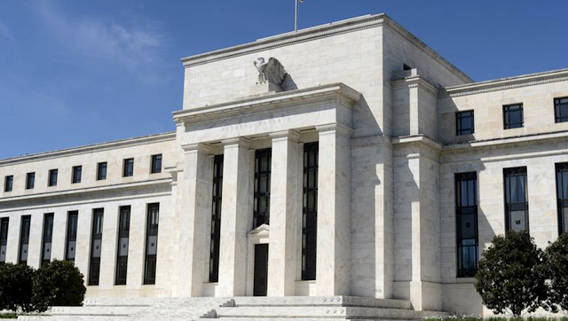 US Federal Reserve holds rates steady, cuts economic growth forecast