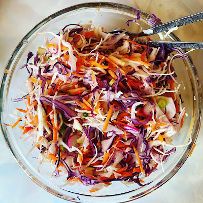 Mixed cabbage and carrot slaw in a bowl