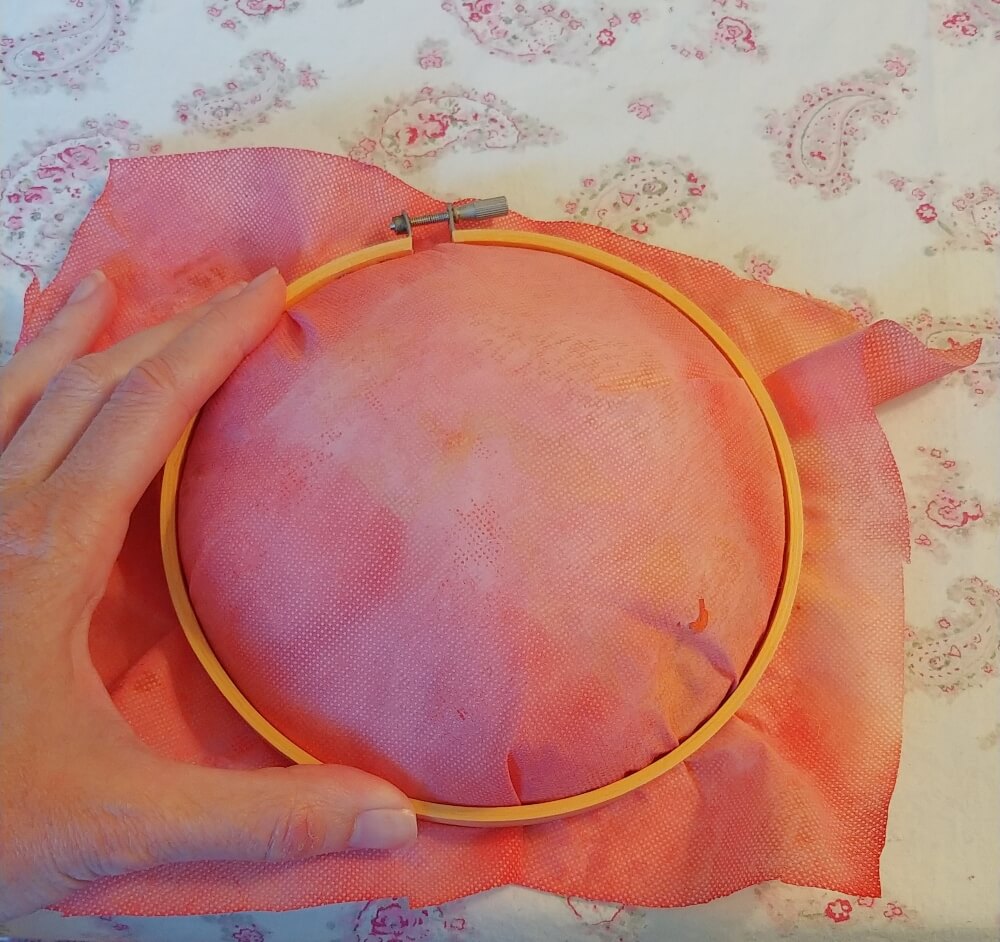 place the top embroidery hoop piece over the fabric