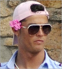 Pretty boy with a flower on his head and a pink cap ... yucks!