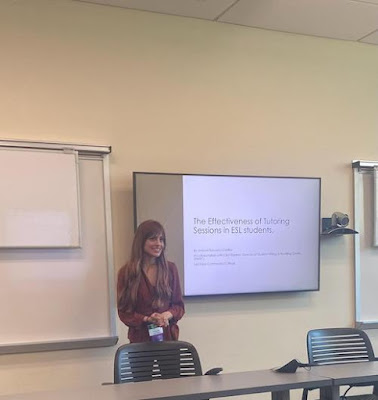 Jessica Ducuara stands next to her research presentation slideshow.