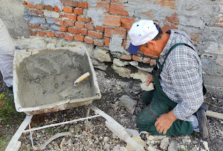 Filling in a hole from the wood store into the enclosure