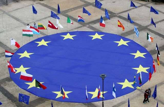 FILE PHOTO: A large European Union flag lies at the centre of Schuman Square outside European Commission headquarters in Brussels, Belgium, May 8, 2021. REUTERS/Yves Herman/File Photo