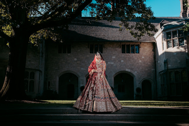 a-woman-in-red-lehenga-standing-on-the-street-while-looking-afar