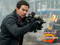 mark wahlberg, he is in action with big gun and black jacket