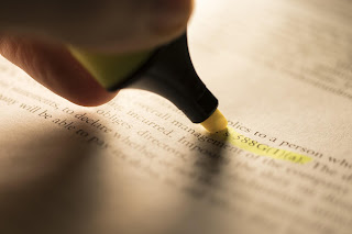 Close up of a highlighter marking text in an article
