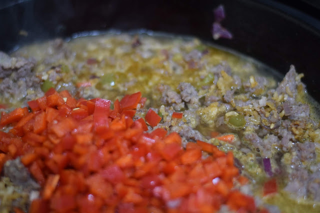 Chicken broth in the pan coming to a boil. 