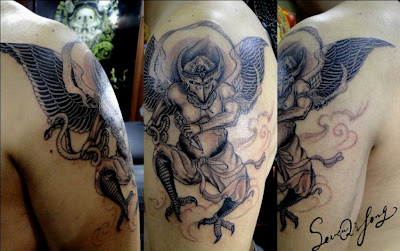 demon tattoo on the arm