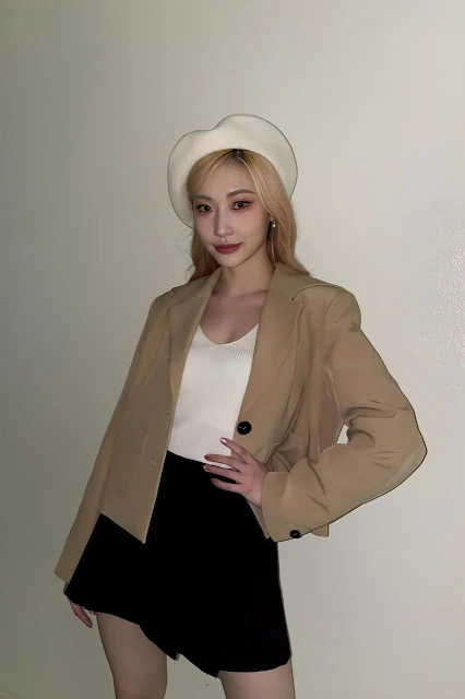 Secret Number Member wearing a white tank top, beige blazer and black mini skirt