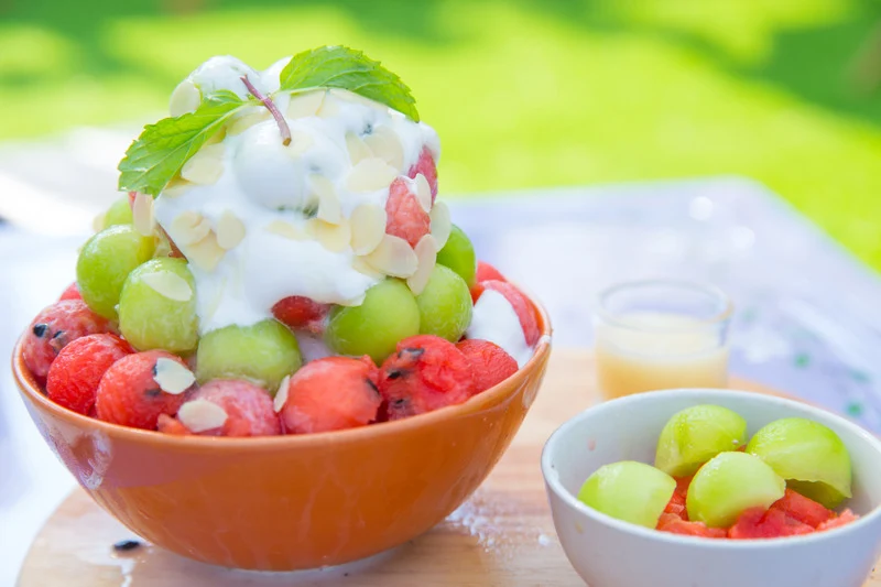 Asian fruit garnishes and a mixed peach whipped drink.