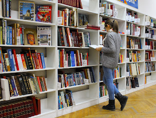 A woman browsing a book store | Ann Arbor hotel