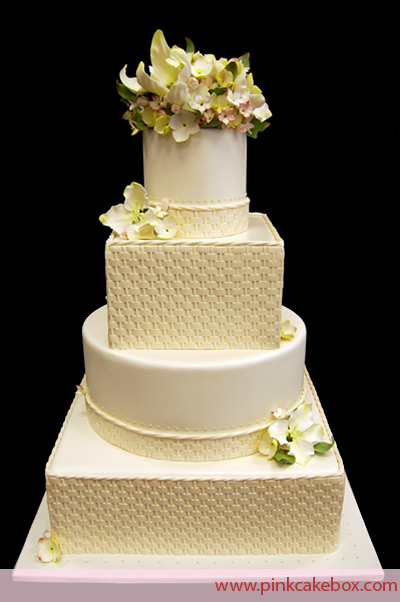 Top and bottom tiers consist of round fondant covered cakes adorned with a