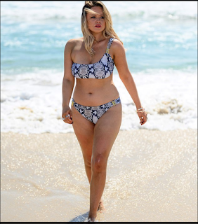 Emily Atack showed off her curves wearing a one-shoulder bikini