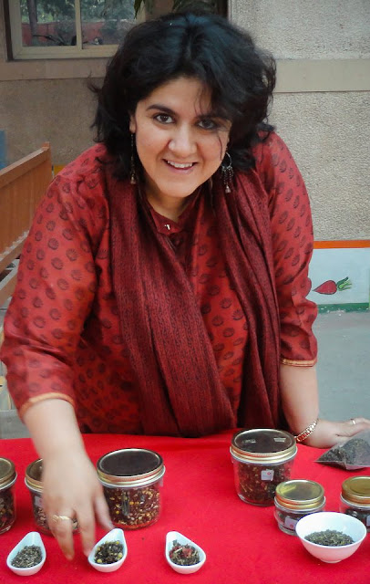  A Tea drinker by birth and a Tea-Taster by profession, Anamika Singh has introduced new infusions with a mix of natural flowers and herbs to the Indian market. Having launched her own brand 'Anandini Himalaya Tea', she conducts Tea tasting ceremonies, conferences & events in Delhi. Her real love is Tea. ‘Identifying, understand and tasting tea we celebrate the very event of drinking tea! Sharing this knowledge with hospitality professionals & clients of real tea is a far bigger challenge‘. Anamika brings on the table knowledge and passion in a delicious brew. Anamika Singh has spent over fifteen years in the tea industry. Starting in Darjeeling as an apprentice under her father, Mr. A. K. Singh (a world renowned tea specialist), she now invests a greater part of the year in the family owned tea gardens in Himachal Pradesh. Research & development in her workshop helps bring out the finest nuances of tea manufacturing and blending. Anamika’s expertise extends to food pairing as part of the sensorial journey to culinary ecstasy.  Navigating between Dharamshala and Gurgaon has allowed her to keep in touch with her traditional ‘purist’ roots as well as the rapidly evolving international market of demanding expats and the Indian tea ‘connoisseurs’. Working in collaboration with exclusive Spas, Star hotels and top restaurants Anandini HT has helped her to be part of this taste revolution. Anamika fires the mindset of  'chaiwallahs' with her dynamic personality and persistence in quality products and presentations. Anandini Himalaya Tea was born as the dream daughter of one of the finest tea producers of India. Anamika Singh, the founder, has taken the whole process of tea manufacturing towards the modern day tea drinking with ‘blends’. They entice you into sharing this divine liquid with breakfasts, lunches, teatime snacks and even dinners. Inspiring blends have been created using the finest real teas and merging with Himalayan flowers and herbs as well as delicate spices from south India. Attached to the roots nurtured by Shri Abhai Singh for over 40 years 'Anandini' marks the evolution towards a consumer friendly palate with an international twist. Sprawled across 650 acres, this bio-diverse tea plantation was begun by the early British planters, over a century ago. It nestles comfortably on the lap of the mighty snow-capped Dhauladhar ranges in the Kangra region of the Himalayas. Like a maestro, this jewel occasionally pulls a veil of mist around it when working on its masterpiece, the First Flush.Kangra district is situated in the Northwest Indian state of Himachal Pradesh. The mountainous region has dramatic landscapes ranging from pine tree-covered slopes to snow covered sub Himalayan mountain range and deep gorges and streams that path their ways in to the valleys and one such is the Manjhee stream which flows along side the Manjhee Valley Tea Garden.  As in all creative cycles there is a starting point and the end result. At the point of balance the beginning and the end merge leaving no trace of either. Great 'Blends' follow a similar path to attain Divine Balance! Green Tea, Pomegranate flowers and Himalayan TulsiThe red pomegranate petals charms its way into the Green Tea liquor with the intense, strong earthy Himalayan Tulsi. The result is love at first sip. It increases healthy metabolism along with the antioxidant potency, which is more then two, or three times of red wine. It compliments crepes with chocolate sauce drizzled over it accompanied with sliced bananas or waffles with fresh fruits or a bowl full of muesli or sprouted lentils with chopped tomatoes, cucumber and fresh coriander.   Green Tea, Rhododendron flowers and Himalayan TulsiGrandeur of Himalayas in every sip.  When each leaf, has melted snow seeped in, Spring greets you in the cup. The delicate flaming red tangy Rhododendron flowers from the high altitude lofty Himalayas mingle gently with the sweet Himalayan Tulsi. The immune booster green tea when blended with the stress reliever Rhododendron petals and Himalayan Tulsi creates the happiness quotient that helps you sail through the day. It supports immunity and strength and stamina and is perfect at 10am. Accompanied with a chocolate chip cookie or a sliced crisp apple it enhances the flavors of tea while leaving an after taste of sweetness.  Or just a piece of dark chocolate..First Flush Tea with Lavender & Lemon GrassA cup of Happiness with whiffs of Serenity ... An exquisite First Flush radiant in cup amalgamates with the fragrant Lavender and the enticing Lemon grass to form the romantic trio. It eases of stress and anxiety. The citral in the refreshing lemon grass has a strong anti microbial and anti fungal properties and is also a detoxifying agent. The calming lavender is a good source of Vitamin A, Calcium and Iron. With bite full of French macaron or a fresh fruit tartlet or a delectable pear and chocolate frangipane tart, traditional Swiss roll or a caramel shortbread of Anzac biscuits, it compliments the flavors.  Green Tea with Chamomile and Rose HipThe sweet intense smoothness of the Chamomile creates a sip of dreams along with the slightly tangy bits of Rose Hip.  Infused into the green tea, it leaves you with a sense of calm. With a warm honey glow and sweet floral notes, the shining star in the nutrition and wellness sector, Green Tea has a higher concentration of antioxidants and bioactive substances. Rose Hip contains 50% more Vitamin C then oranges and blueberries. When sipped after dinner, it eases of stress and tiredness. It compliments a chocolate soufflé or almond ricotta cheesecake or tiramisu.Method of InfusioFor 1 cup (200ml): In a pot add 1 teaspoon of Anandini Blend. Pour 1 cup of water (200 ml) heated at 95 degrees C. over the Blend. Infuse for 4 minutes. Strain and Sip.Check out more about Anamika and her brain-child Anandini Himalayan tea http://www.hindustantimes.com/Entertainment/Food/Tea-trail/Article1-922654.aspxhttp://www.dailypioneer.com/vivacity/86686-secret-of-the-leaves.htmlhttp://www.youtube.com/watch?v=b8vnH2X1-FE&feature=sharehttp://healthfooddesivideshi.blogspot.in/2012/08/tea-with-anamika-singh-when-master-tea.htmlhttp://www.mytastycurry.com/2012/08/tea-tasting-and-food-pairing-event-by.html?fb_action_ids=4556295904914&fb_action_types=og.likes&fb_source=aggregation&fb_aggregation_id=246965925417366http://deyatanu.blogspot.in/2012/09/afternoon-teaand-something-more.html